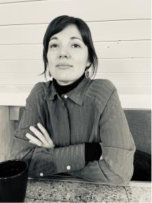 A female author sits at a table.