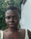 black person with short hair and a green top