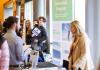 Student holding #HireHuskies sign at UW Career Fair