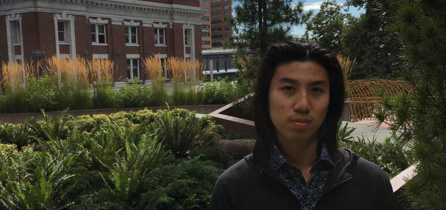 Geography student Kevin Ho with King Street Center building near Pioneer Square